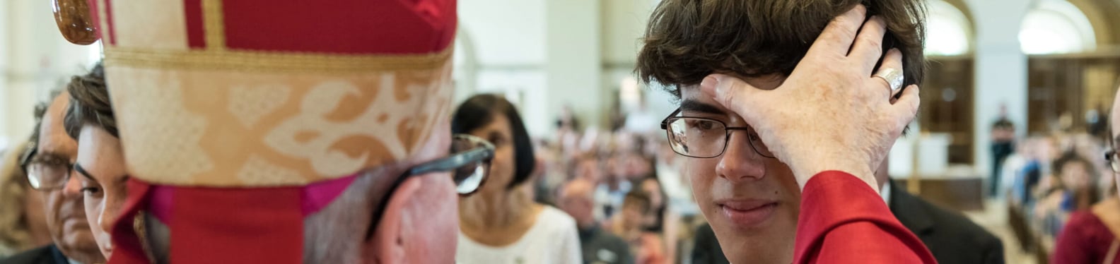 Confirmandi receiving the Sacrament of Confirmation from the Bishop