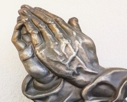 Silver hand joined together in prayer